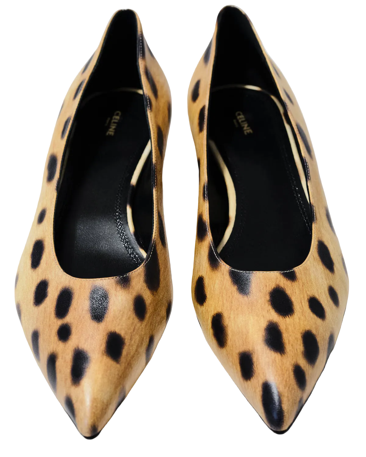 A pair of pointed-toe Celine pumps in a tan and black leopard print, photographed from a top-down angle on a light gray background.