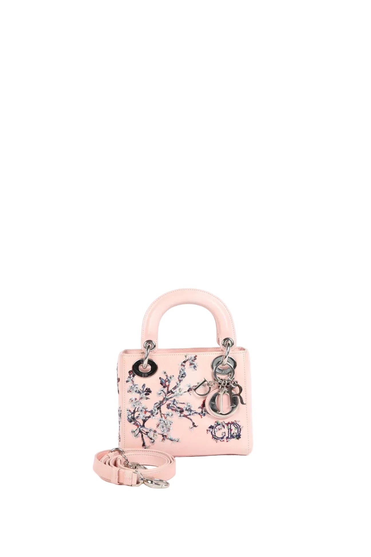 A small light pink leather handbag with floral embroidery, silver-tone hardware, a top handle, and a detachable shoulder strap, photographed on a clean white background.