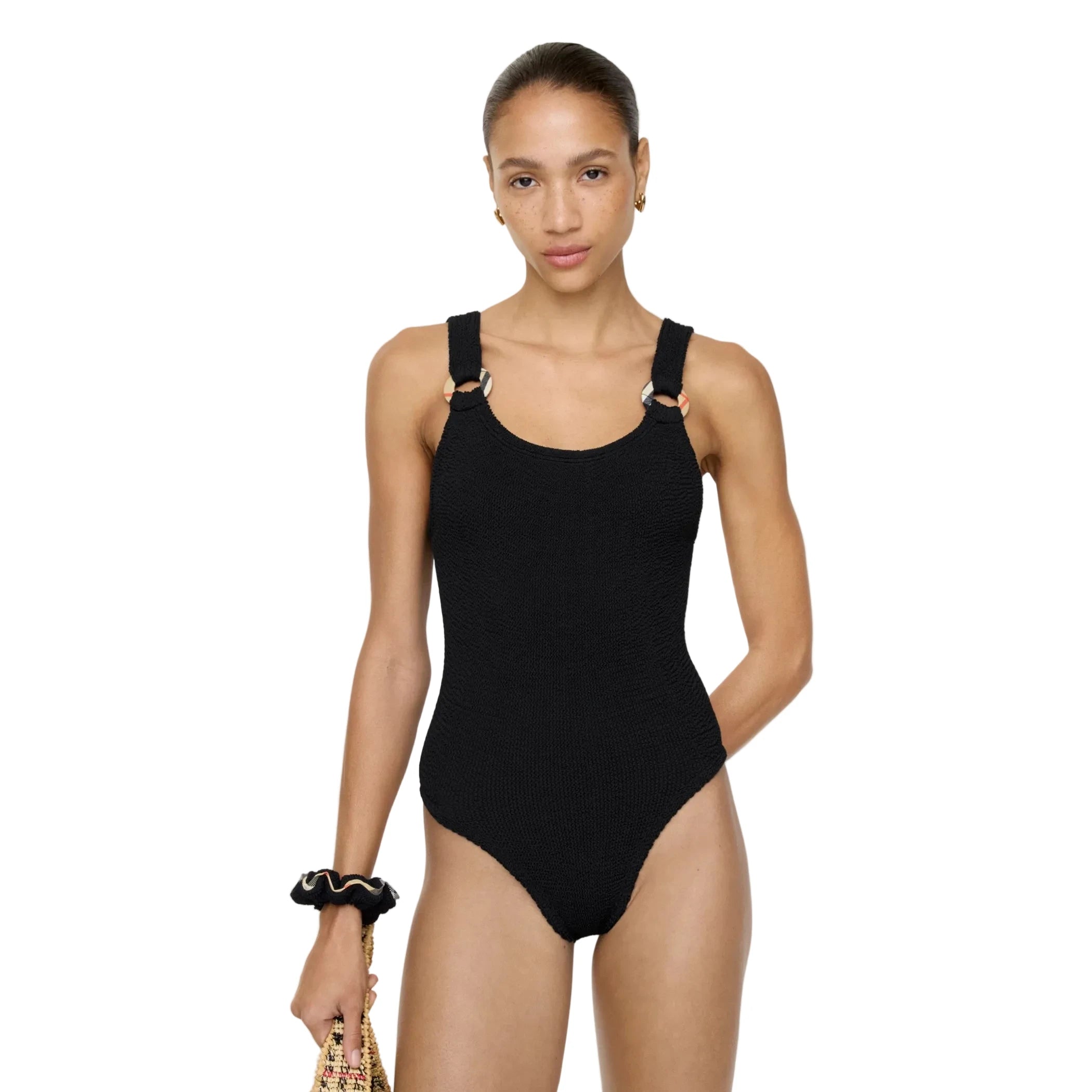 Woman wearing a black swimsuit against a white background