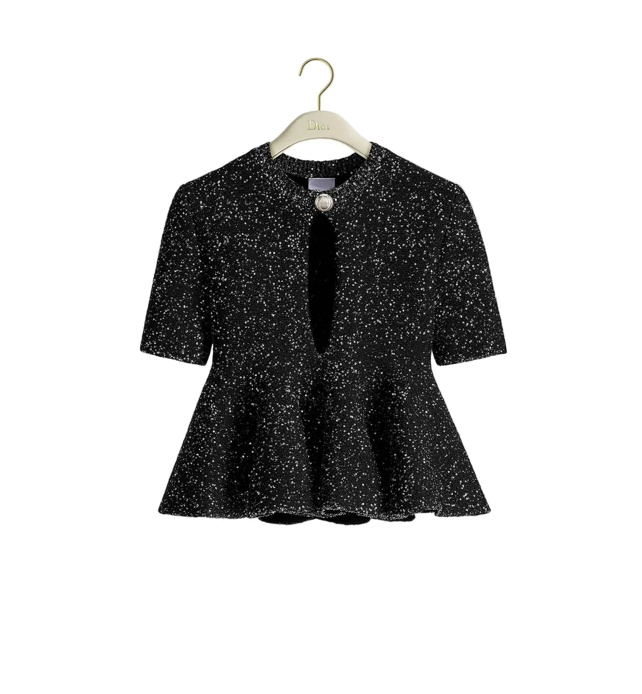 A black short-sleeve peplum jacket with a white speckled pattern, hanging on a light wood hanger with a gold hook against a plain white background.