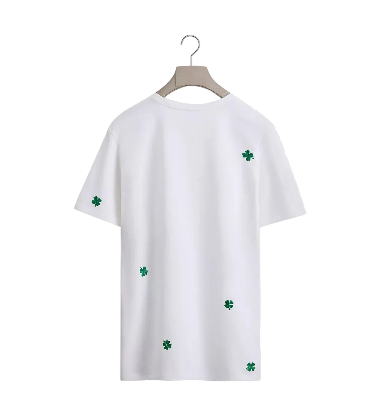 White t-shirt with green four-leaf clover patterns on a white background