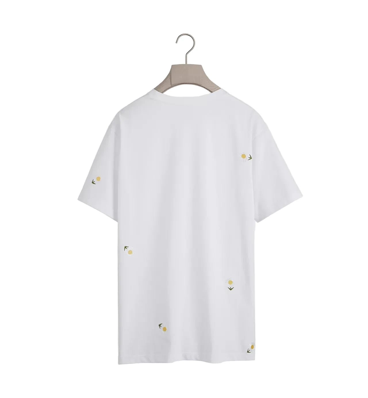 White t-shirt with small yellow patterns on a hanger against a white background