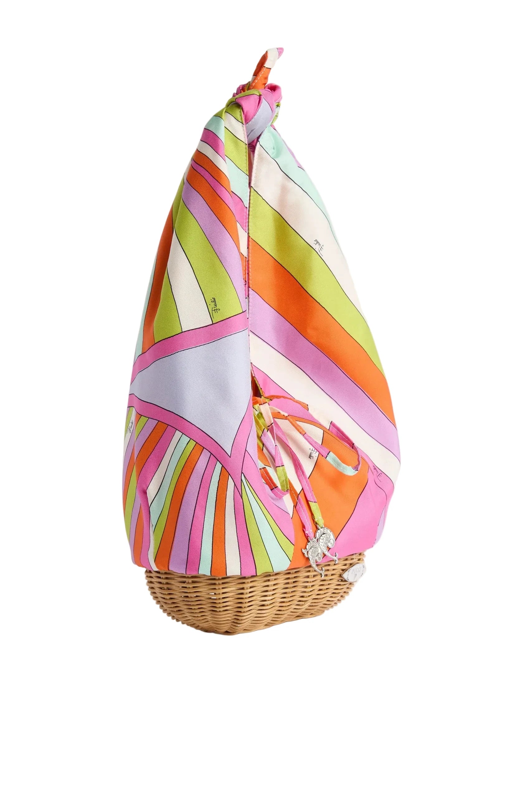 Colorful striped fabric draped over a wicker basket on a white background