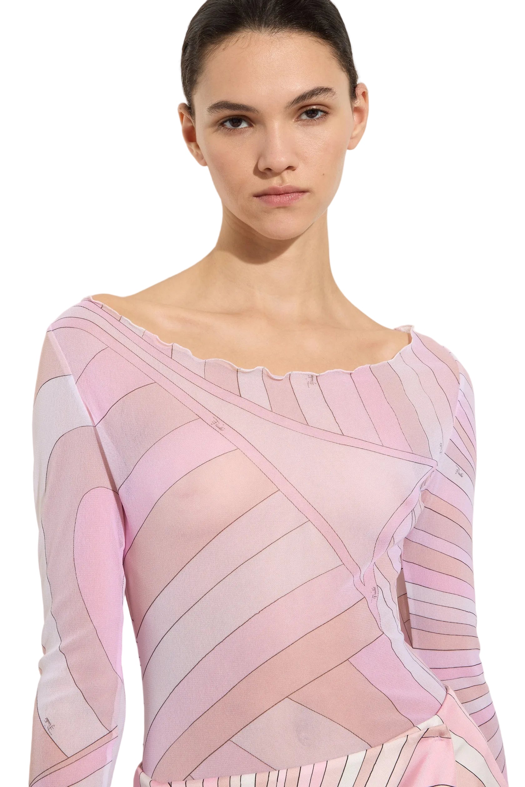 Woman wearing a pink and white patterned dress against a plain background