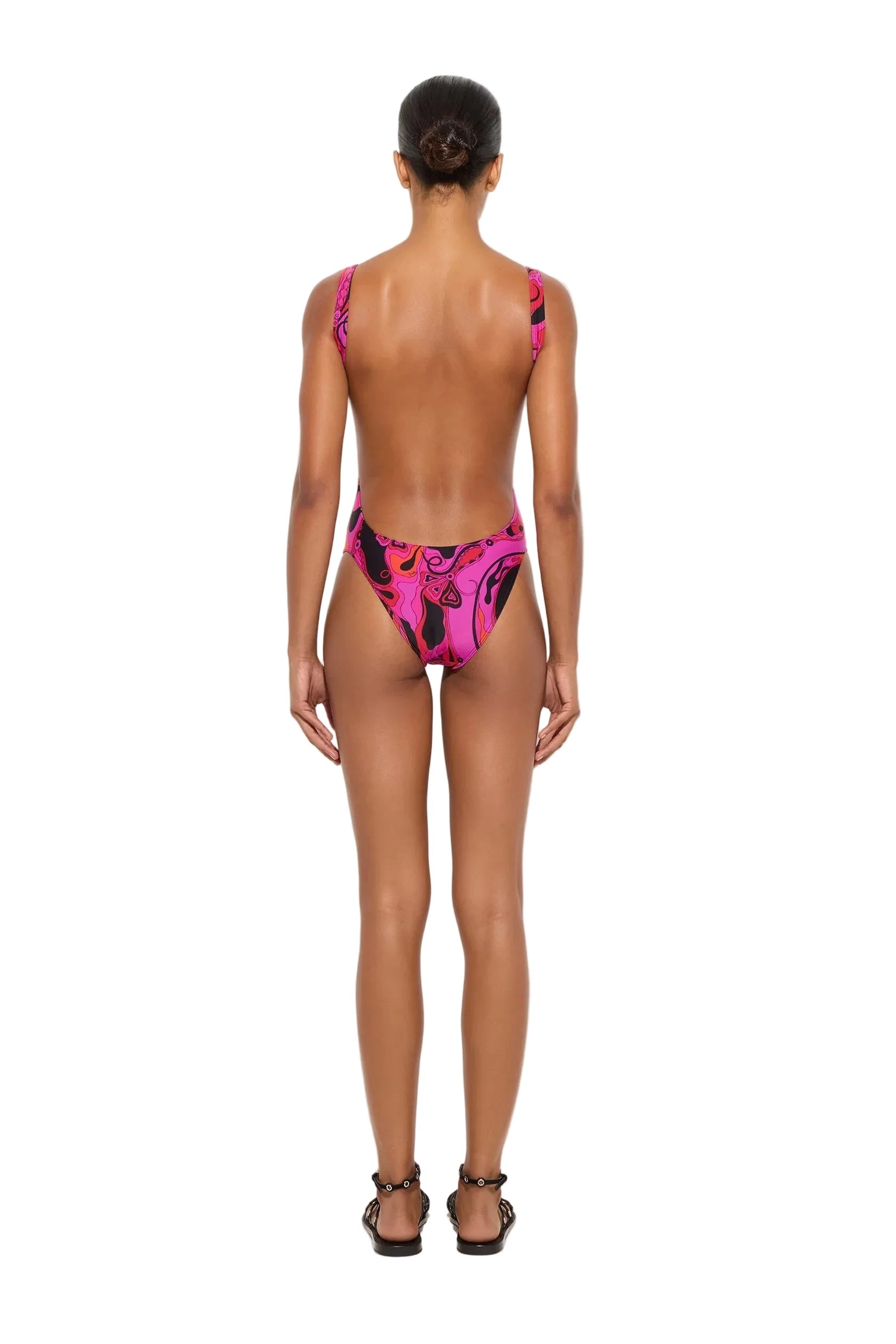 Person wearing a pink and black patterned bikini on a white background