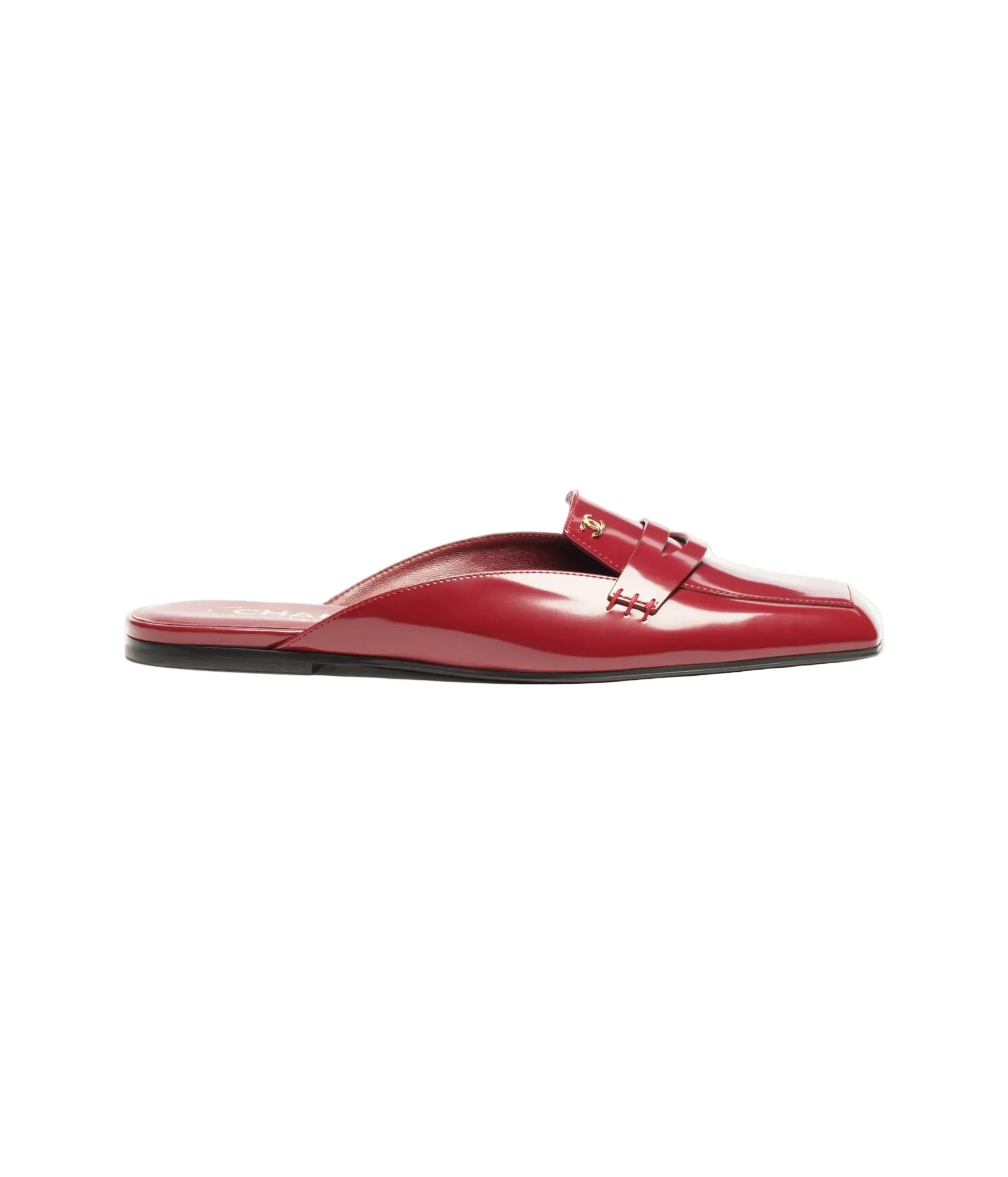 A single red patent leather mule sandal with a decorative strap and gold-tone hardware, shown in profile against a plain white background.