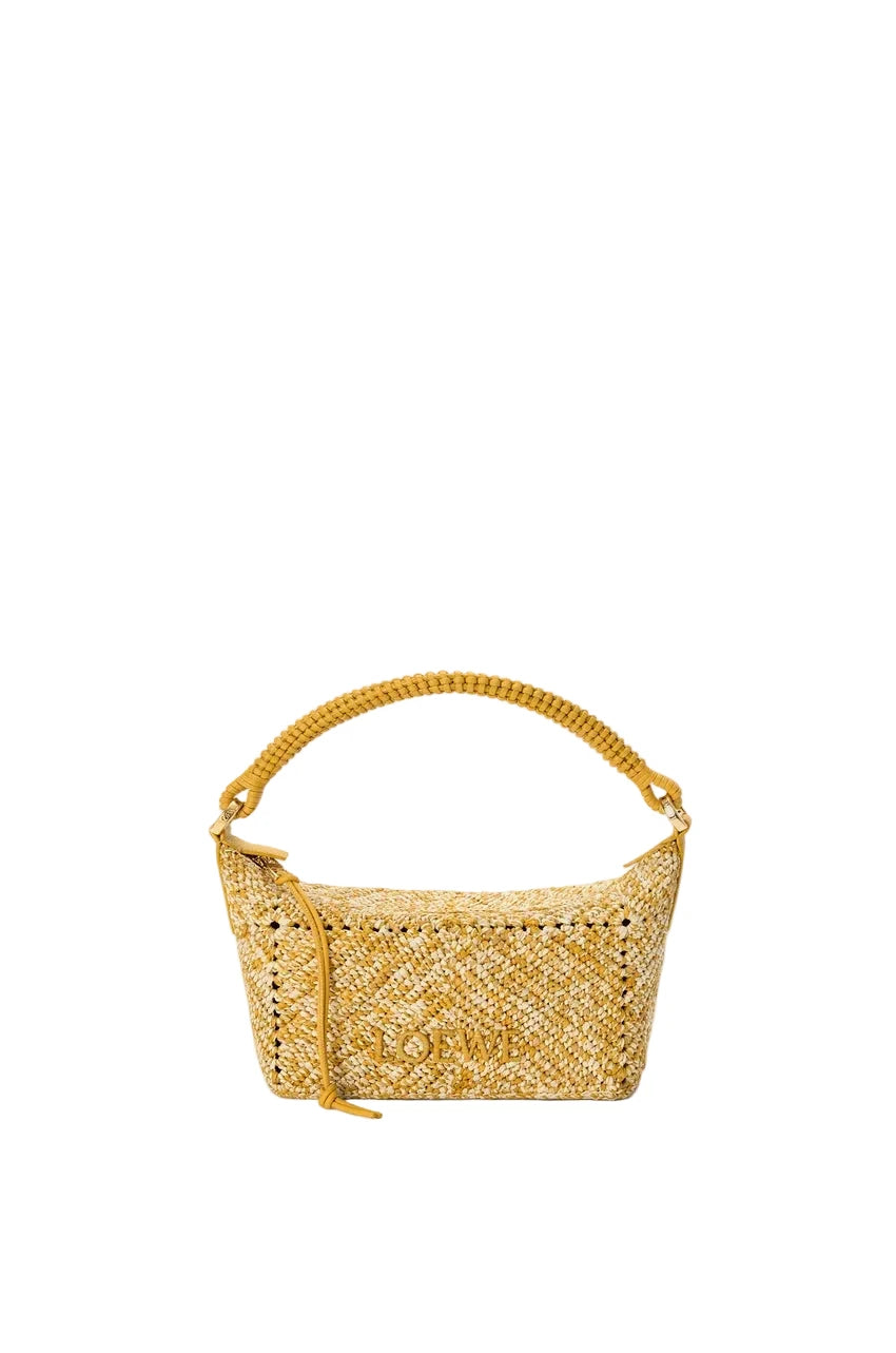 Yellow woven handbag on a light gray background