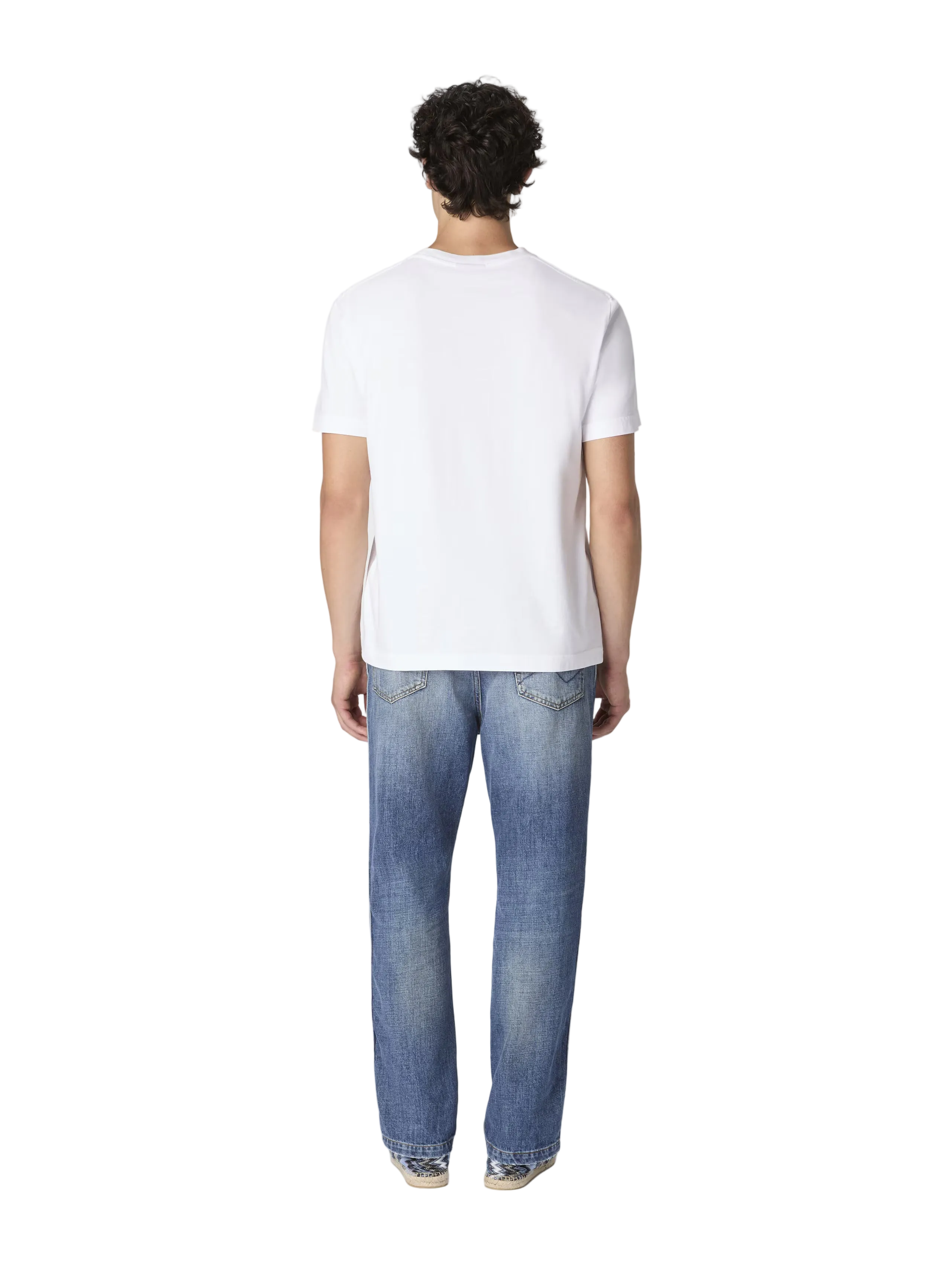 Person wearing a white t-shirt and blue jeans on a white background