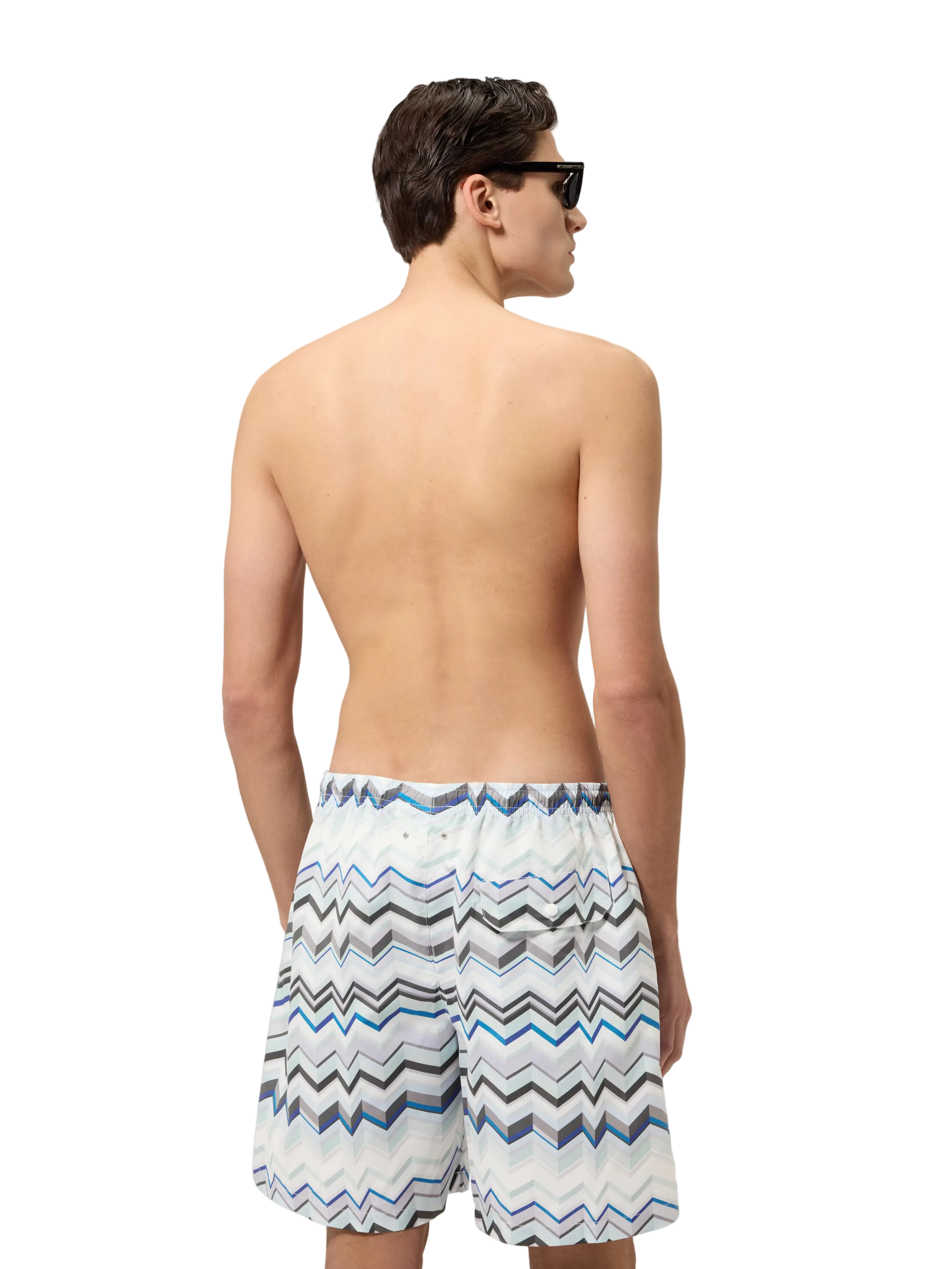 Man wearing a patterned swimsuit on a white background