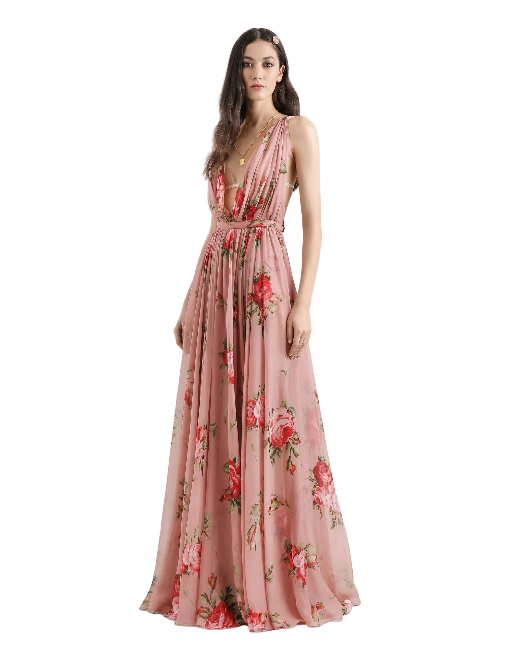 Woman wearing a pink floral dress on a white background