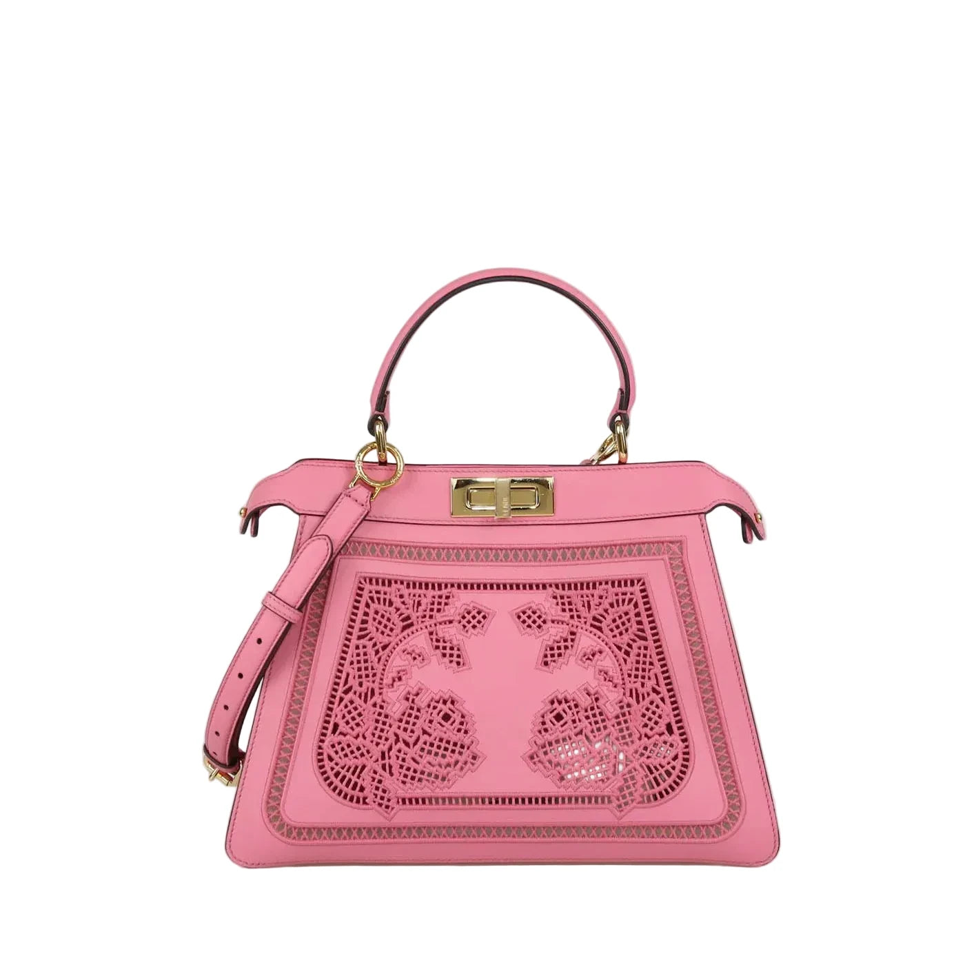 A pink leather handbag with a top handle, gold-tone hardware, and a decorative laser-cut floral panel on the front, photographed against a plain light gray background.