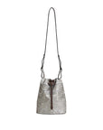 Silver drawstring bag with floral patterns on a light gray background