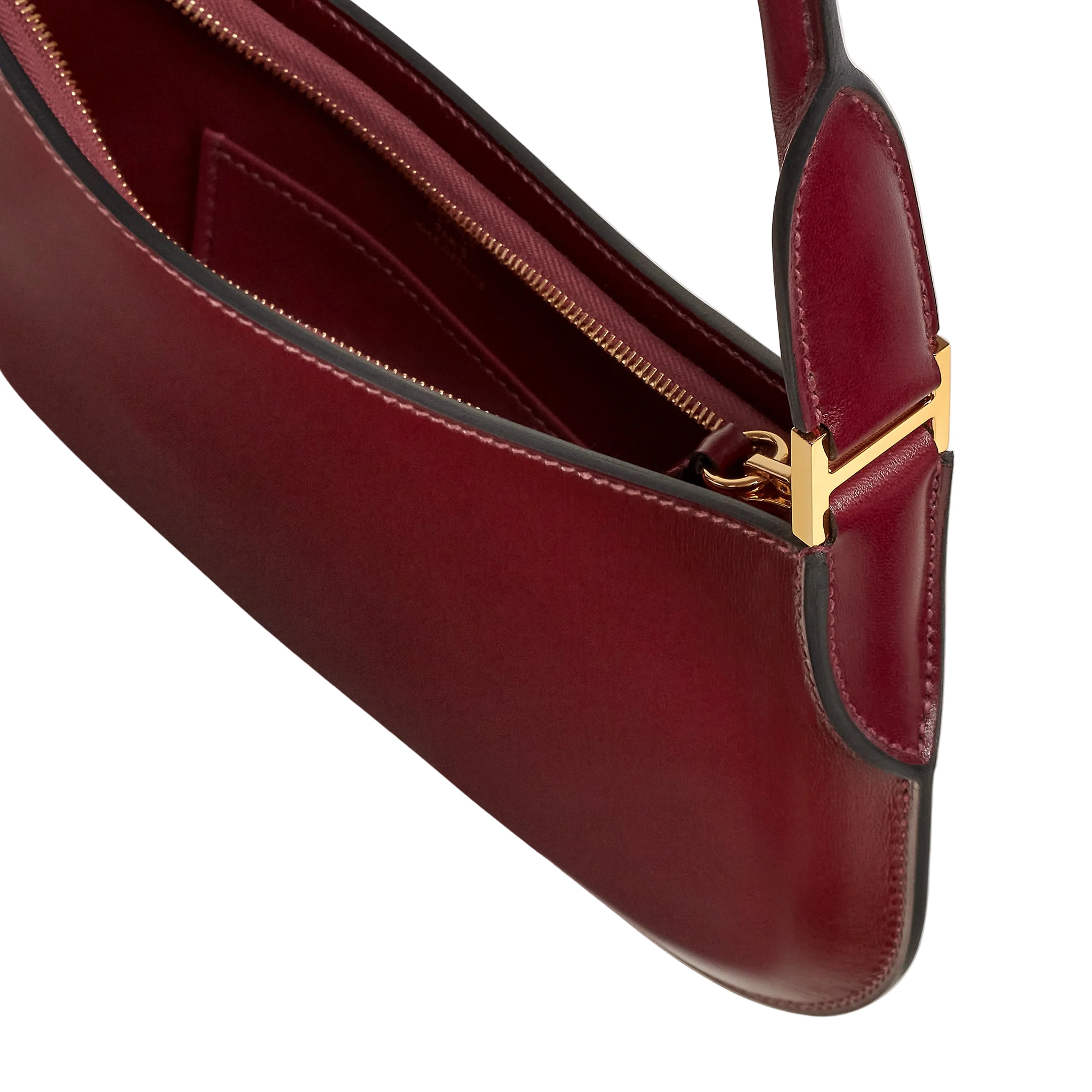 Red handbag with a gold clasp on a light beige background