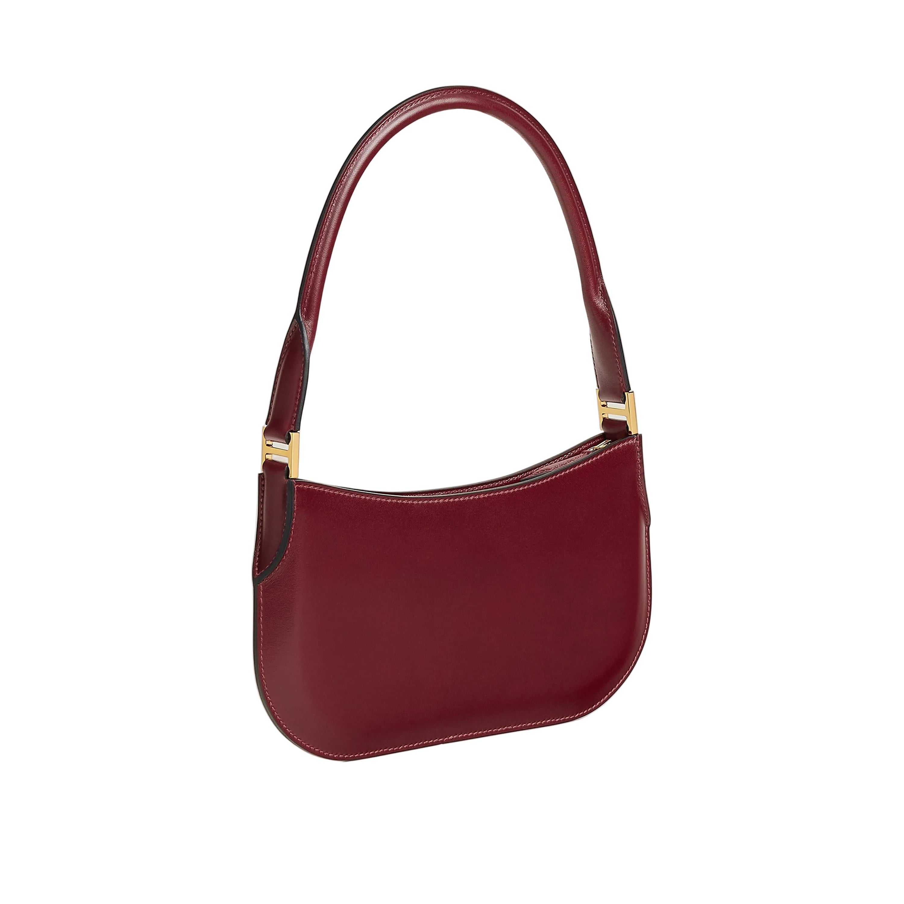 Red handbag with gold accents on a light beige background