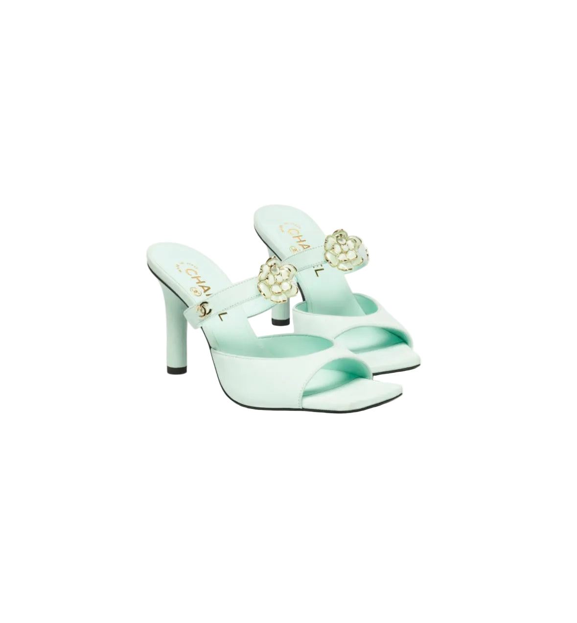 Mint green high-heeled shoes with floral embellishments on a white background