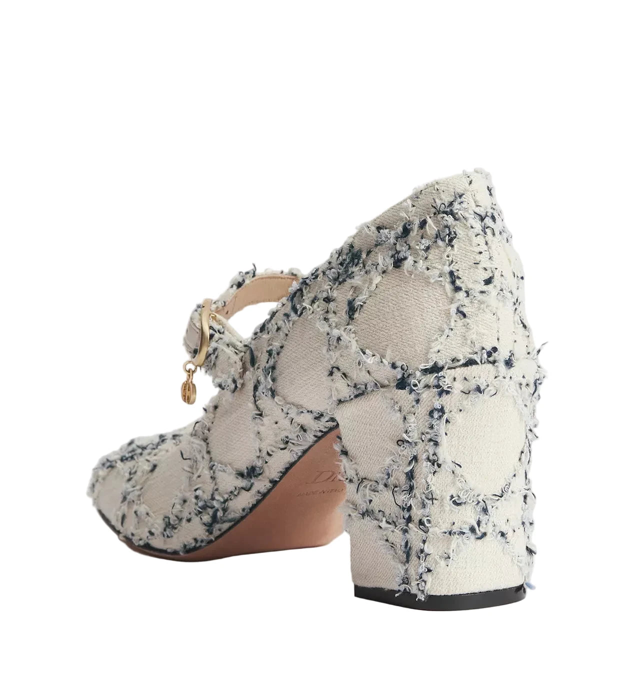 A single women's block-heel pump shown from a rear three-quarter angle on a light gray studio background. The shoe features a textured tweed upper in off-white, beige, and black, with a small gold-tone charm on the strap and a tan insole.