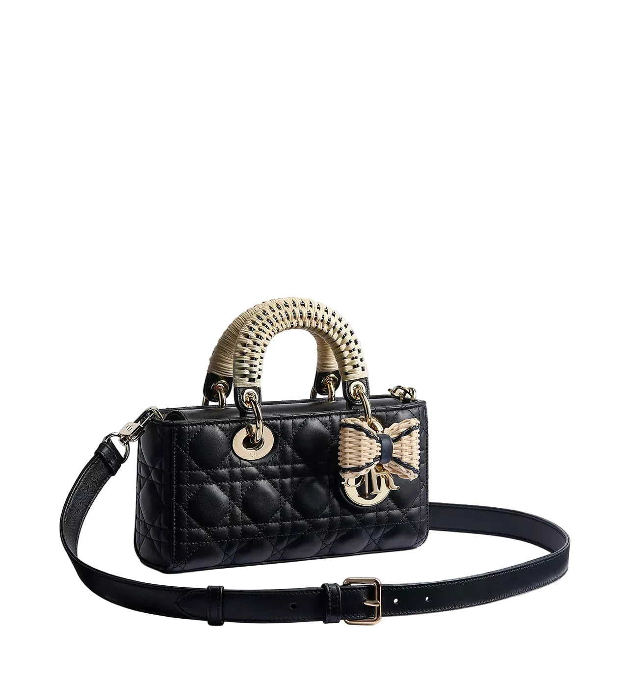 Black quilted handbag with gold accents on a light gray background
