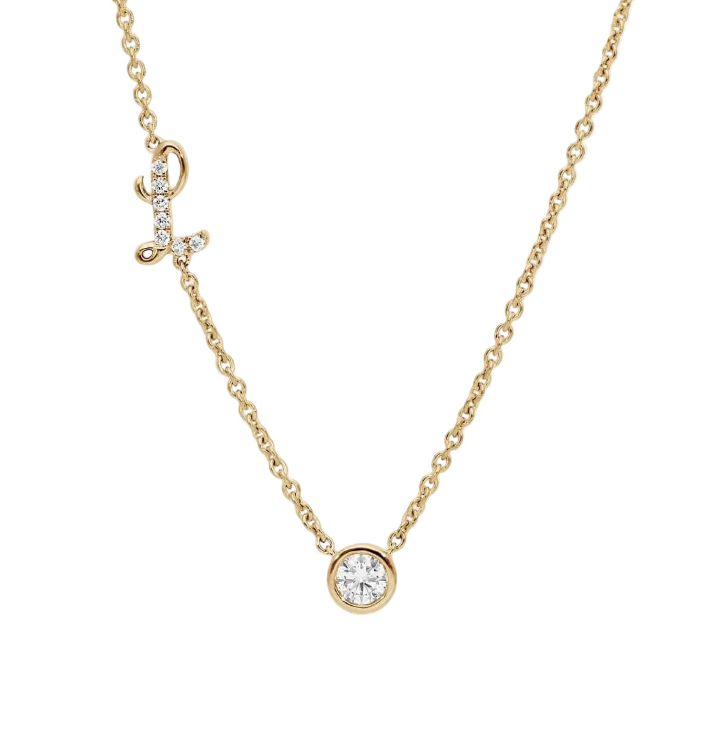 Gold necklace with a round diamond pendant on a white background