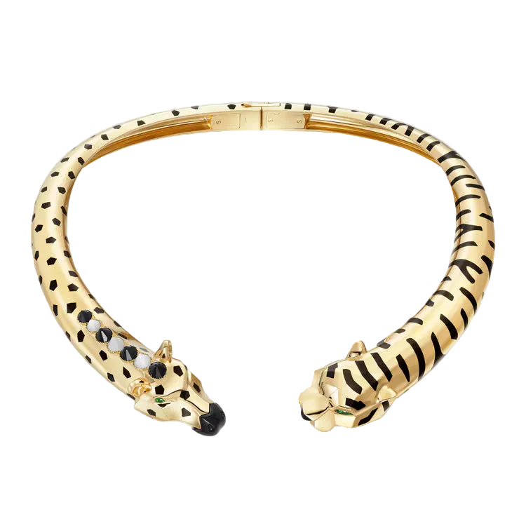 Gold bracelet with leopard and tiger head designs on a light gray background