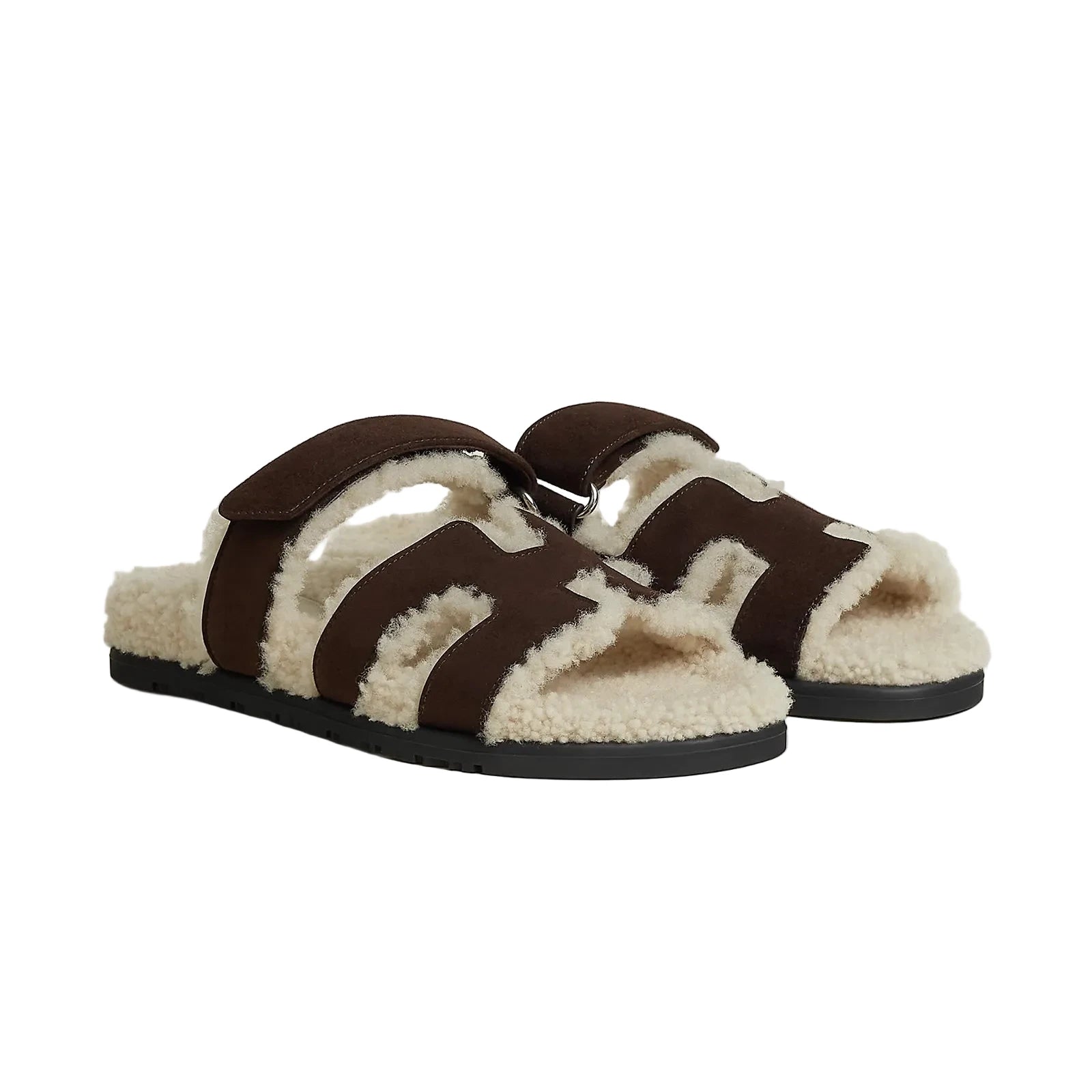 Pair of brown and white slippers on a light beige background