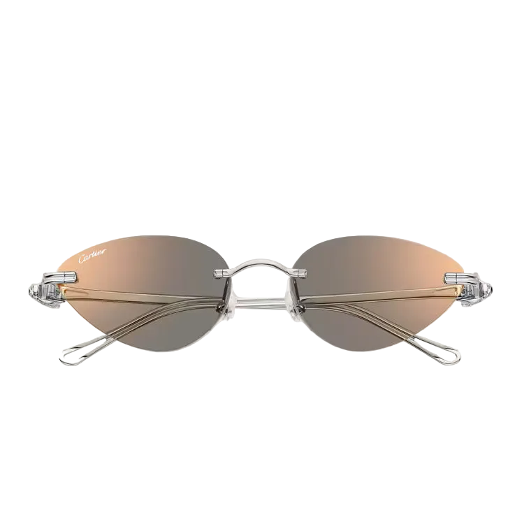 Oval rimless sunglasses with a silver metal frame and mirrored lenses that transition from warm bronze-gold at the top to dark gray at the bottom. The Cartier logo is visible on the left lens.