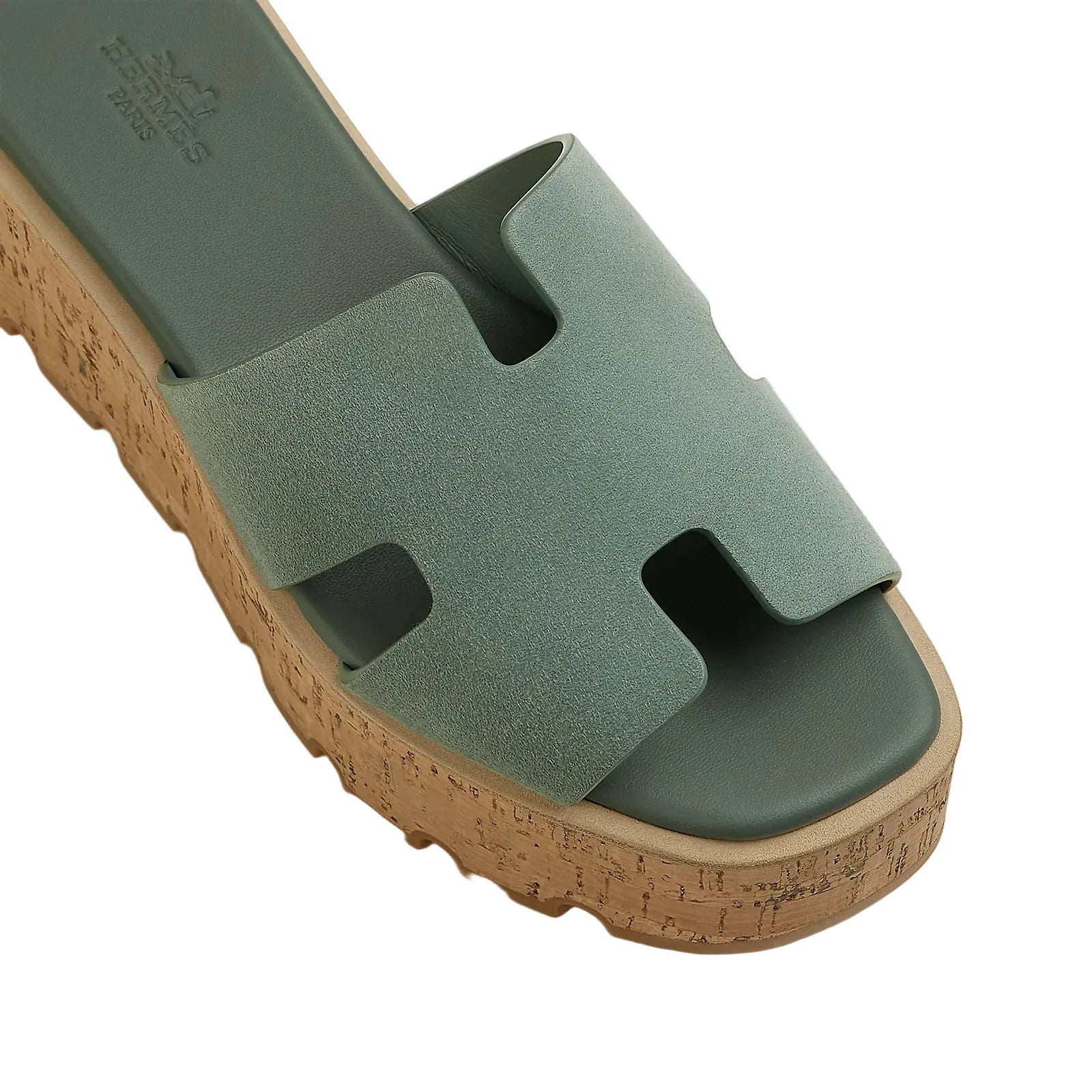 Green sandal with cork sole on a light gray background