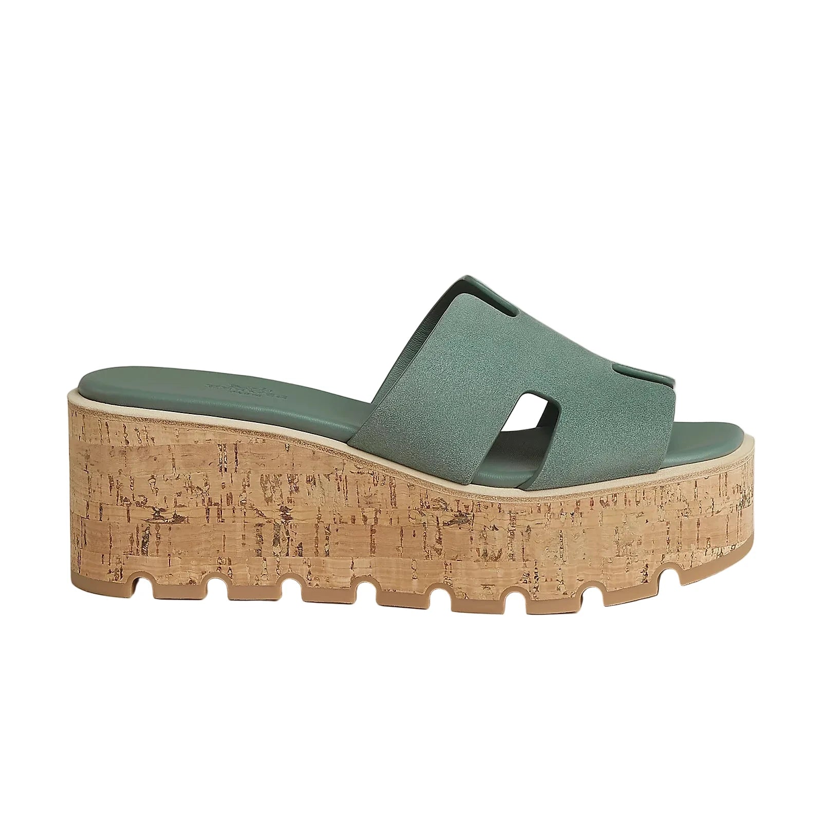 Green sandal with cork wedge sole on a light gray background