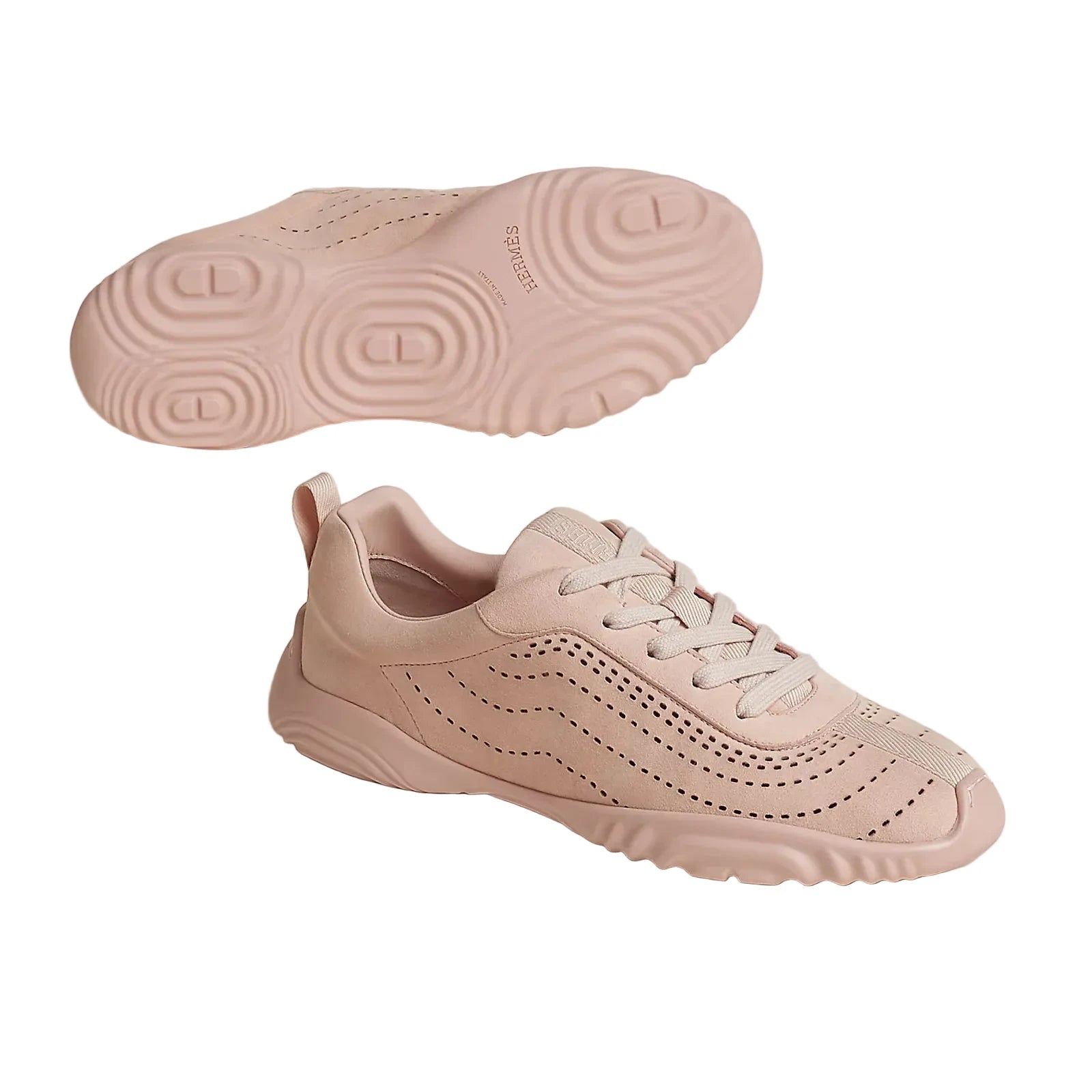 Pink sneaker with sole showing brand logo on a light background