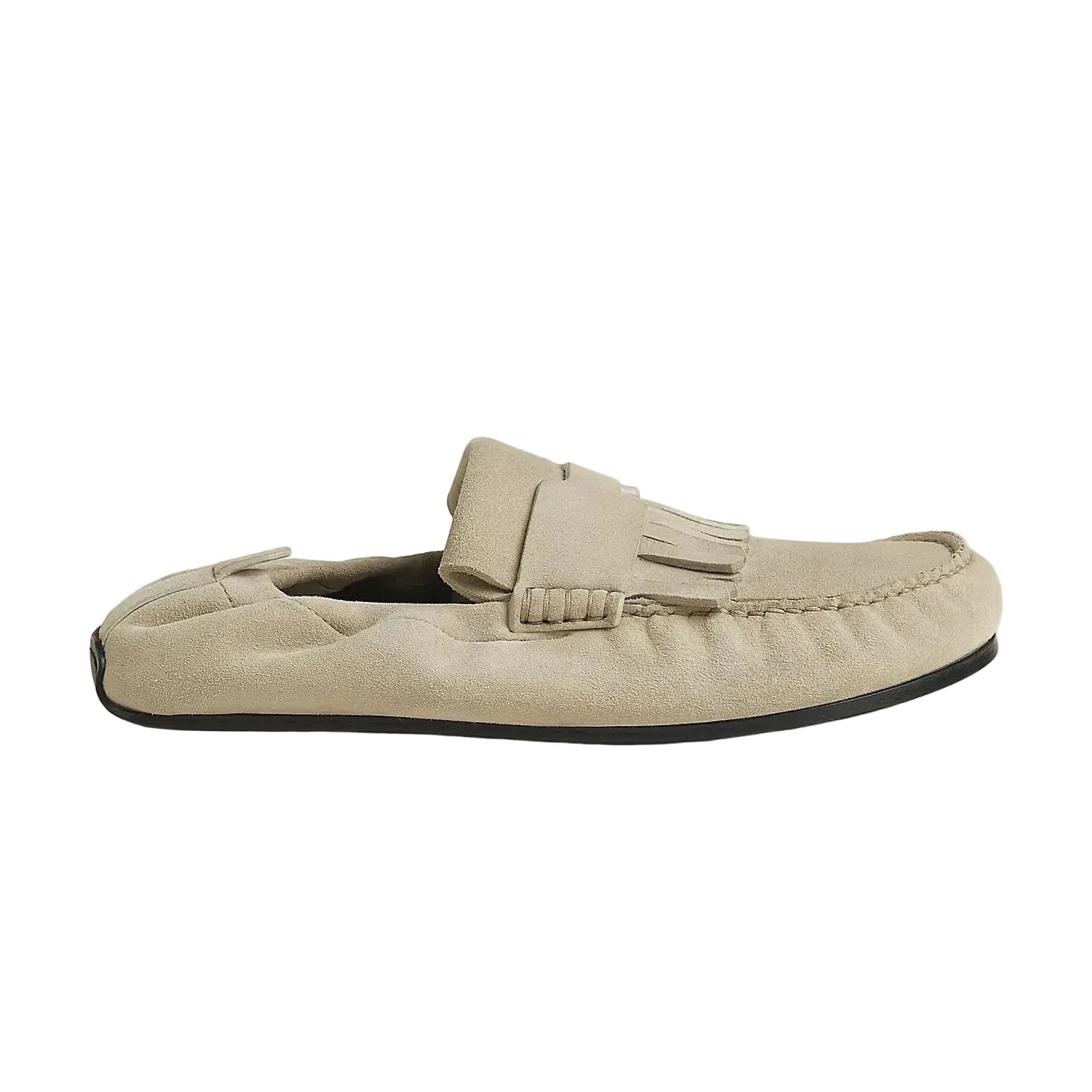 A single light beige suede moccasin loafer with a decorative strap and tassel detail, shown in profile against a solid light beige background.