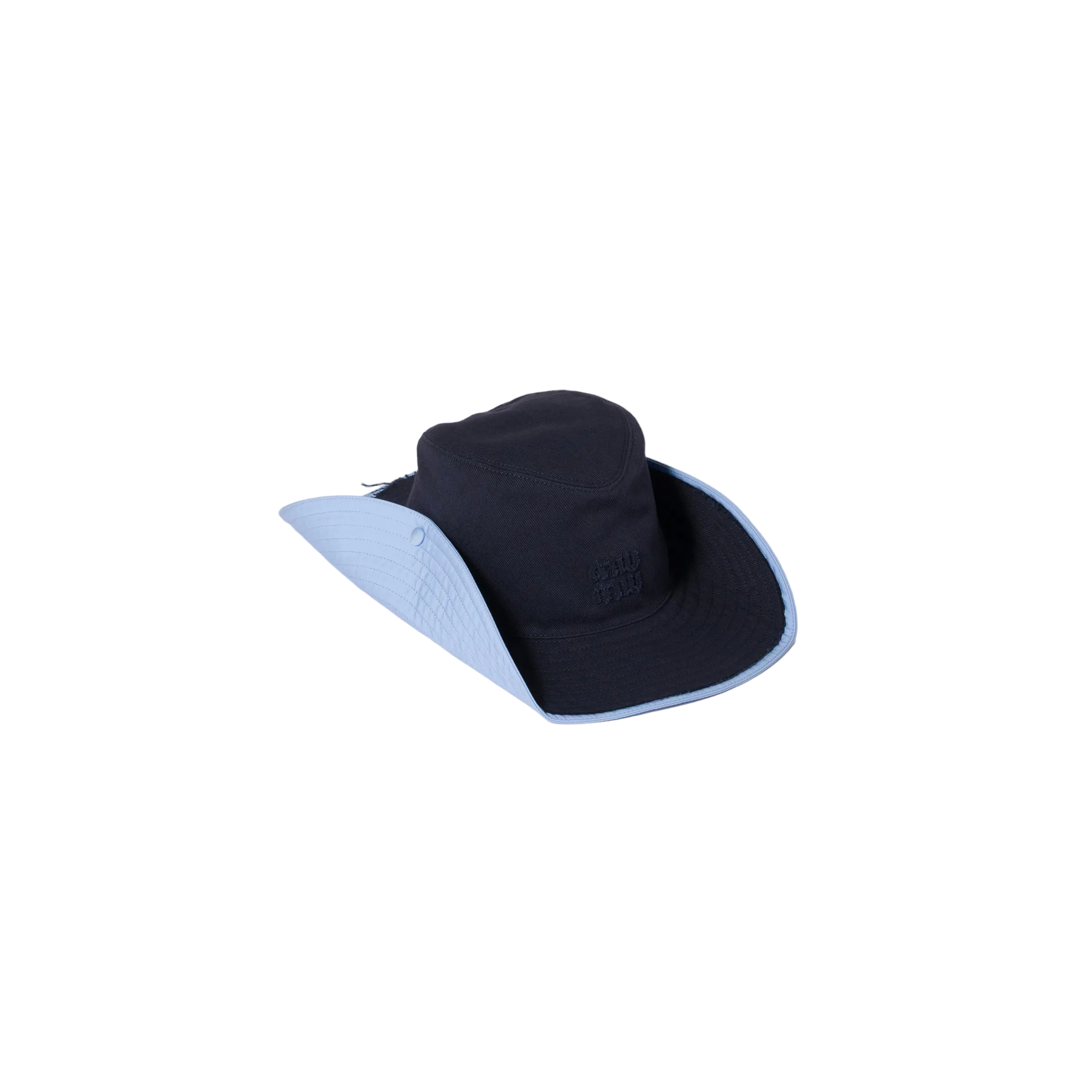 Black bucket hat with blue rim on a beige background
