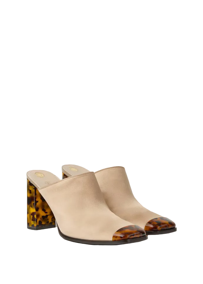 Pair of beige high-heeled shoes with tortoiseshell accents on a white background