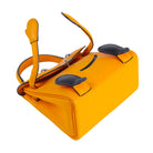 A bright yellow leather handbag with black leather accents and silver-tone hardware, photographed on a clean white background.