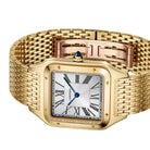 A Cartier watch with a gold-tone metal case and integrated bracelet, featuring a silver-toned square dial with black Roman numerals and a blue hour hand.