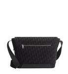 Black crossbody bag with a subtle pattern on a light gray background