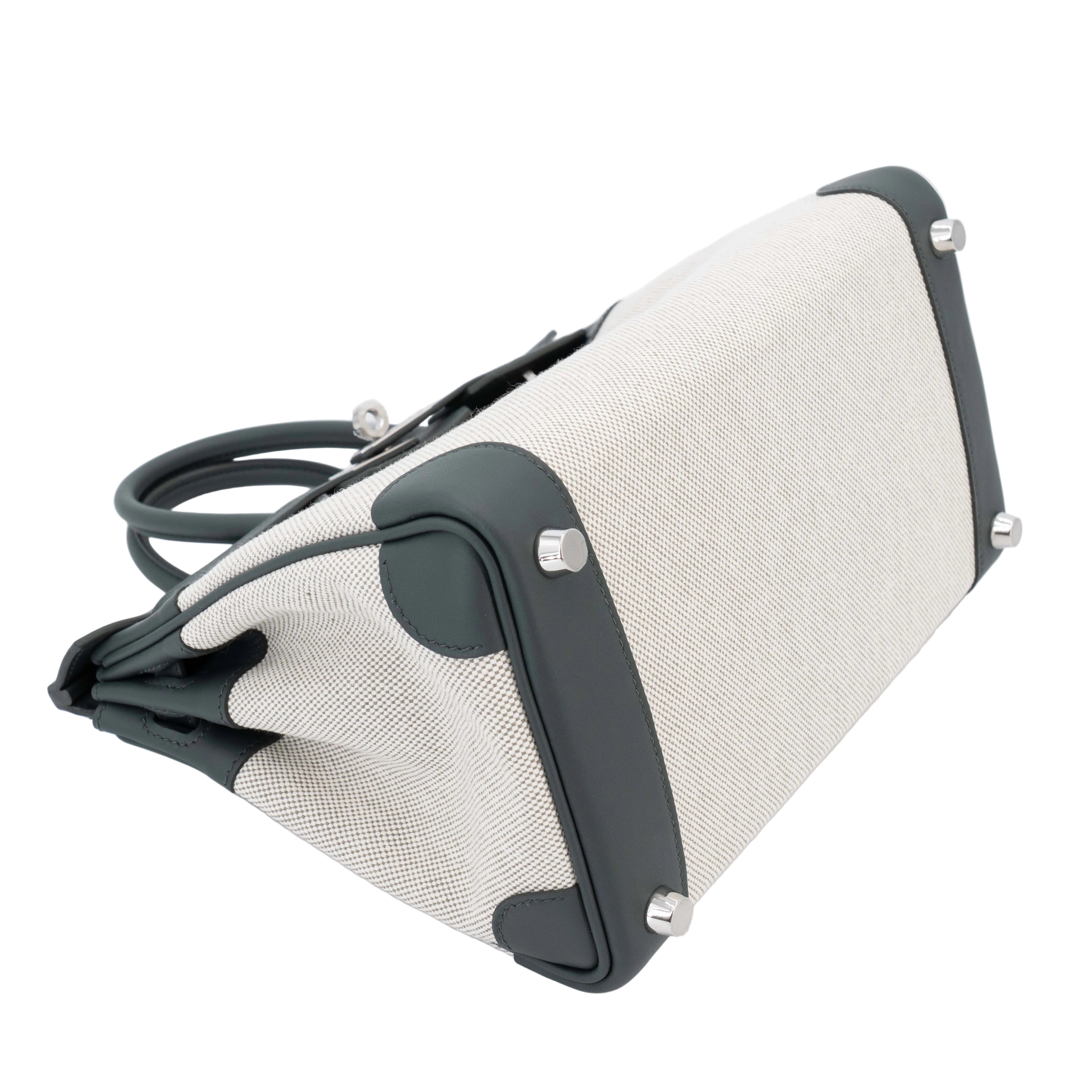 Close-up of a beige fabric bag with black straps on a white background