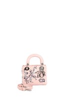 A small light pink leather handbag with floral embroidery, silver-tone hardware, a top handle, and a detachable shoulder strap, photographed on a clean white background.
