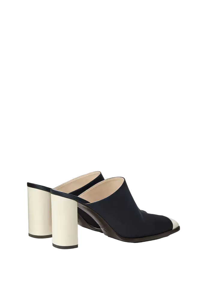 Black high-heeled shoes with white soles on a light gray background