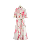 Floral dress on a hanger against a white background