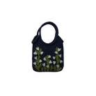 Navy blue handbag with floral embroidery on a beige background
