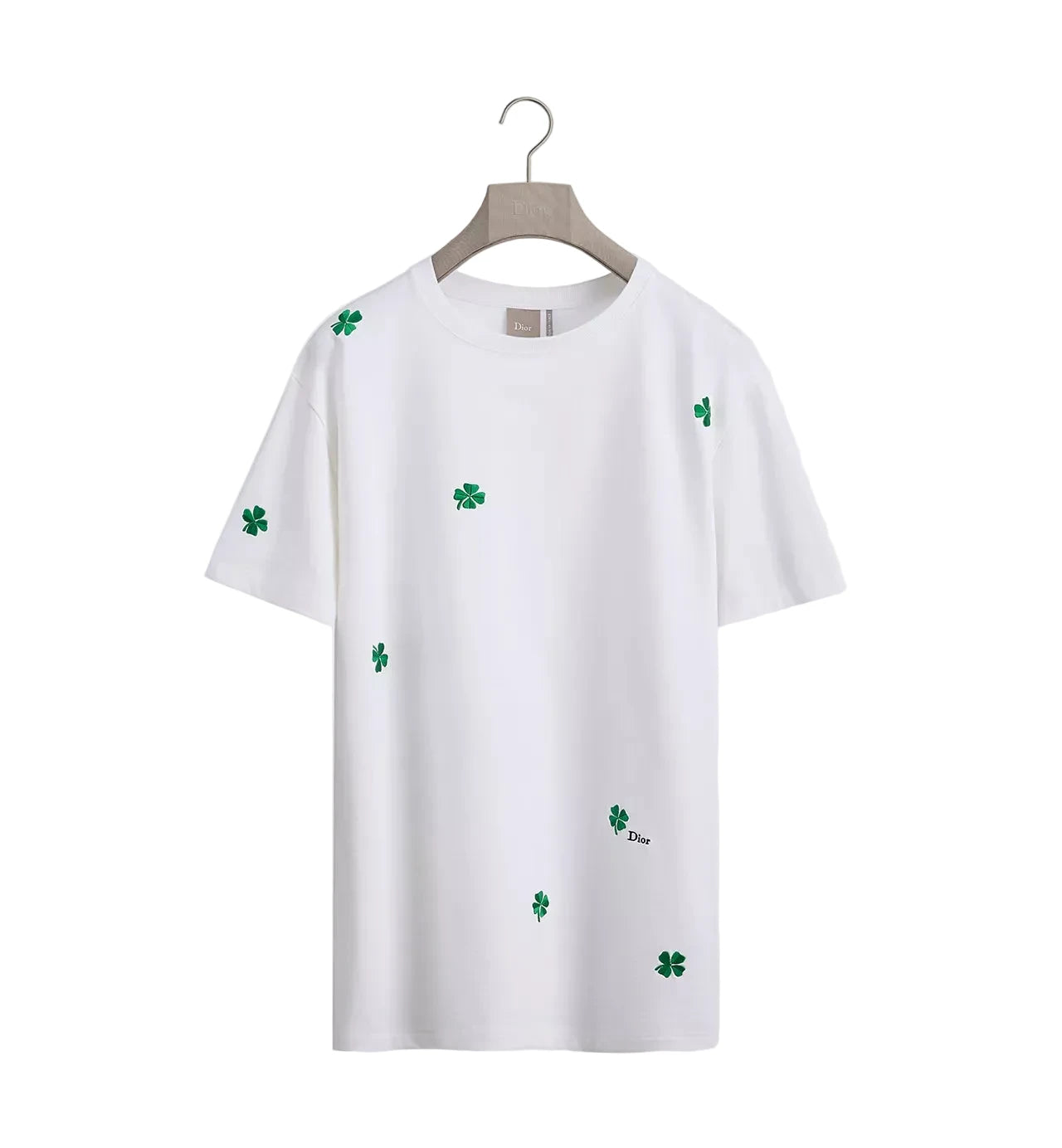 White t-shirt with green clover patterns on a white background