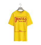 Yellow t-shirt with 'Dracula by Bram Stoker' and 'Dior' text on a hanger against a white background