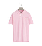 Pink polo shirt with brand logo on a hanger against a light gray background
