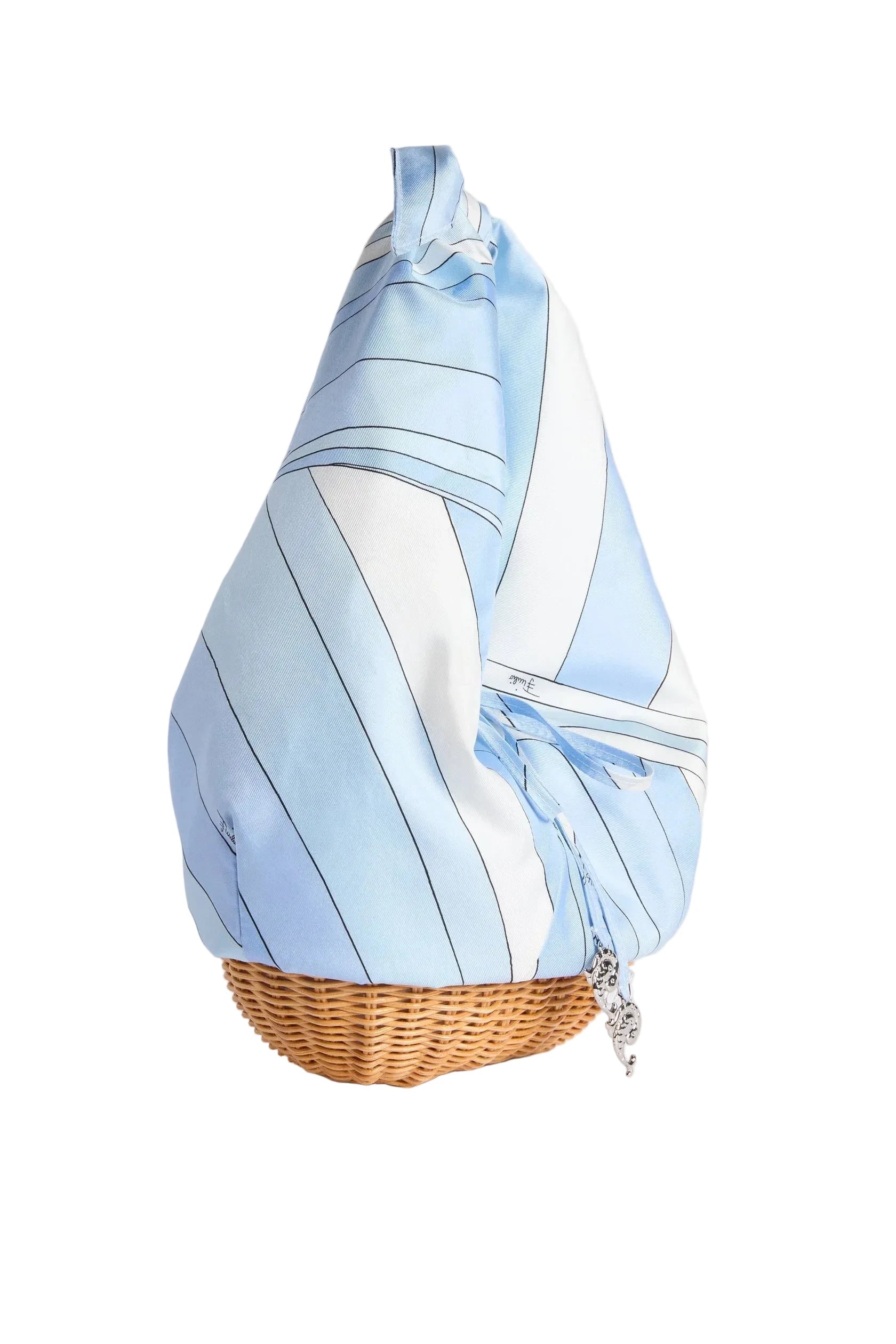 Blue and white patterned handbag with a woven base on a light gray background