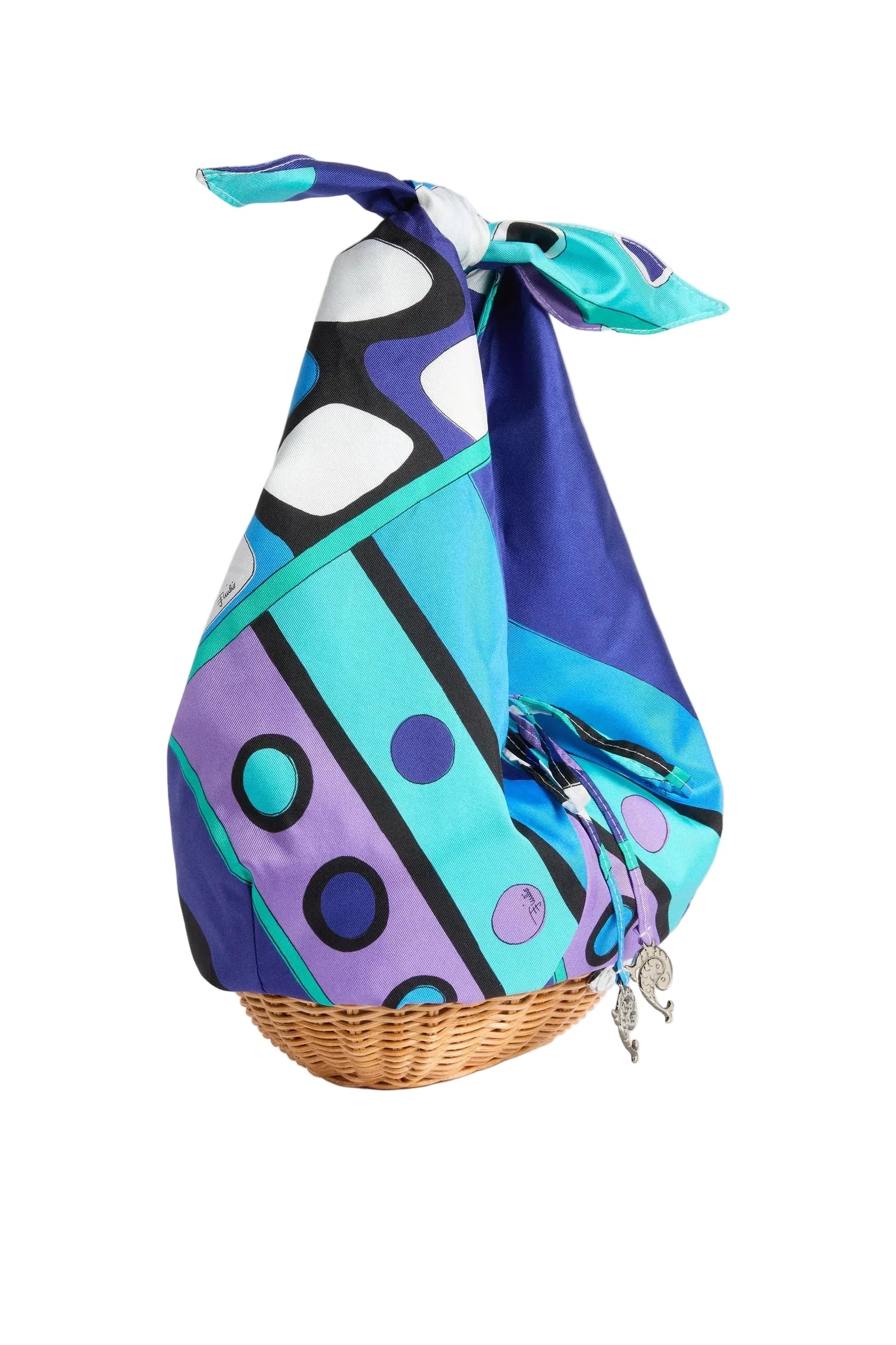 Colorful scarf with abstract pattern draped over a woven basket on a white background