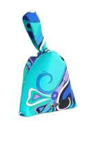 Colorful handbag with a pattern on a light gray background