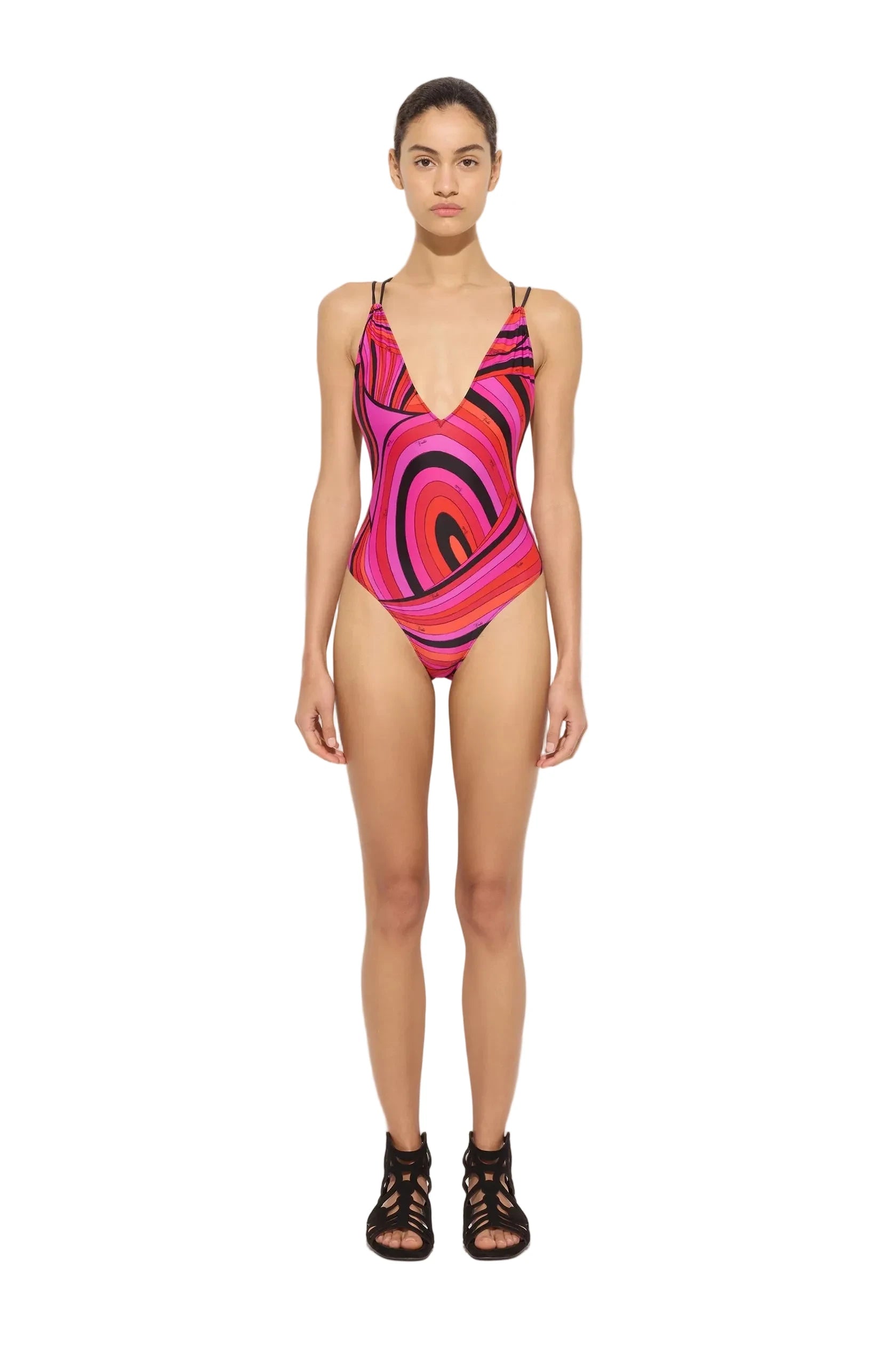 Model wearing a colorful swimsuit on a white background
