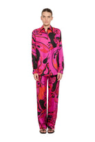 Model wearing a vibrant, multicolored outfit with a pattern on a white background