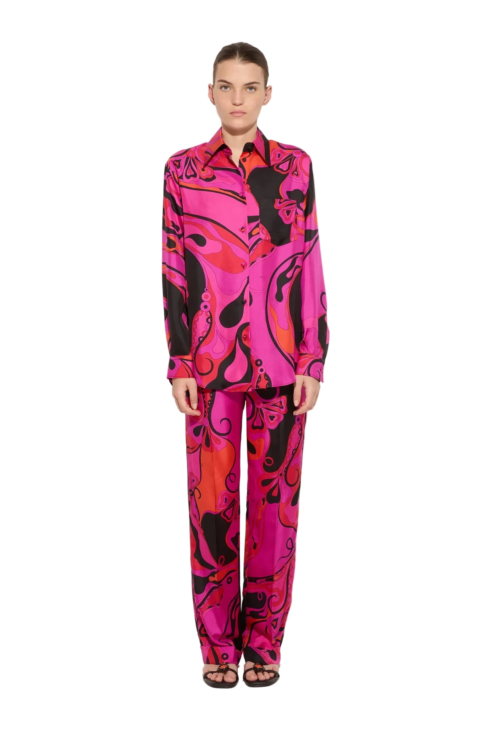 Model wearing a vibrant, multicolored outfit with a pattern on a white background