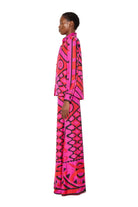 Person wearing a vibrant, patterned outfit on a white background
