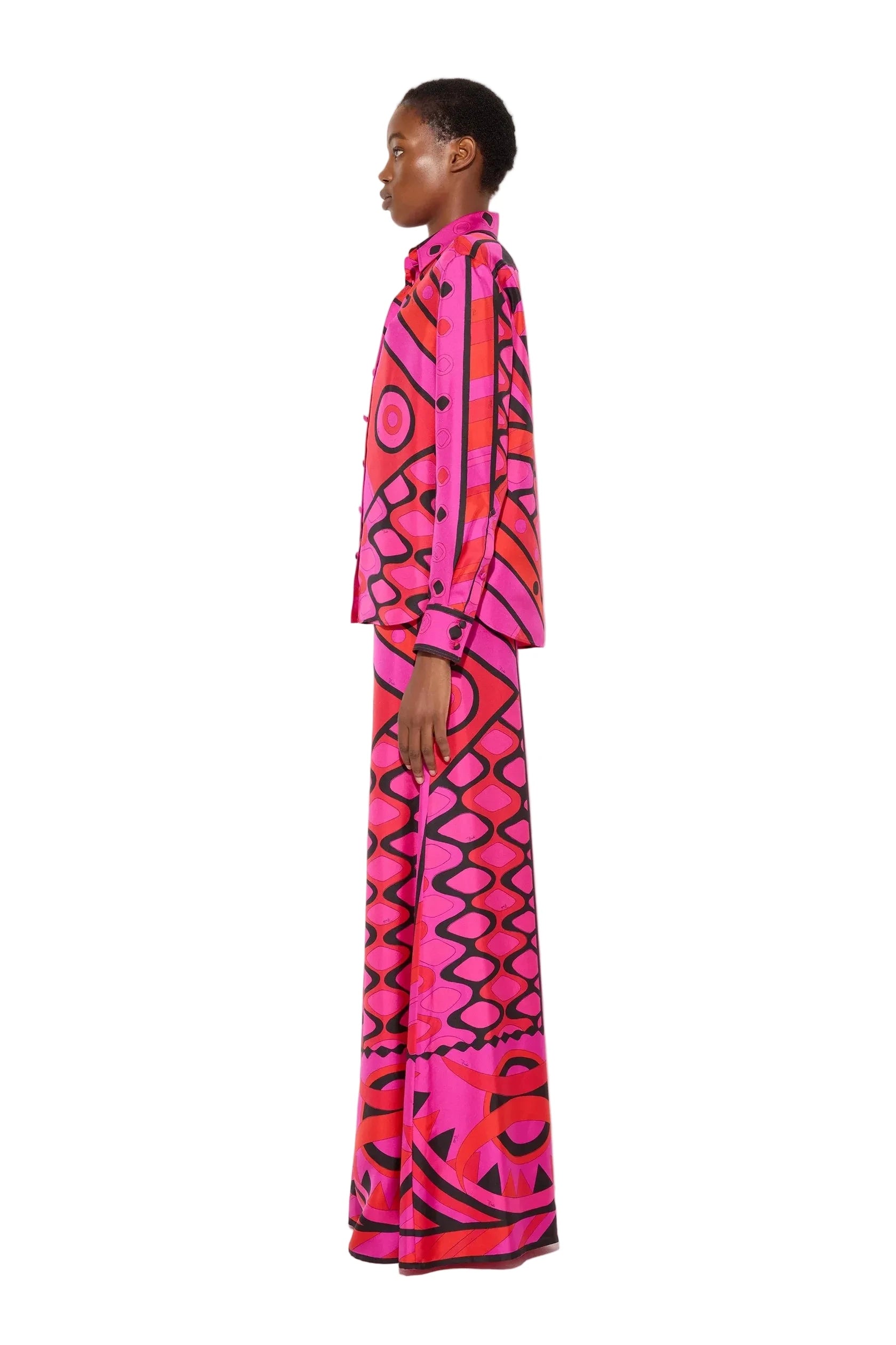 Person wearing a vibrant, patterned outfit on a white background